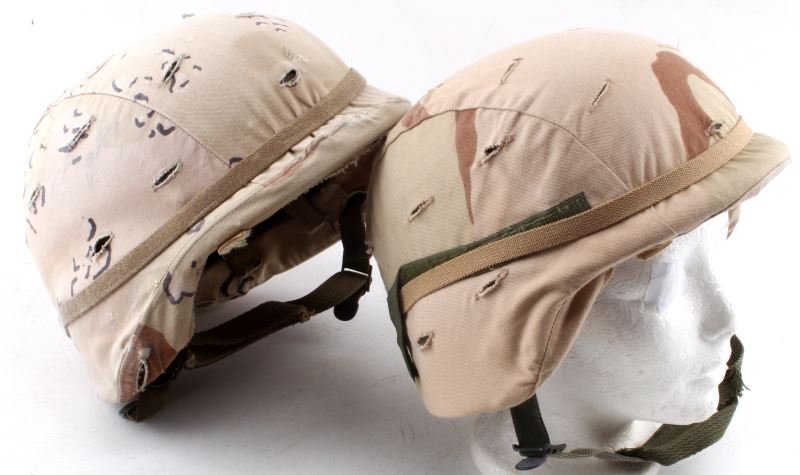 2 US PASGT KEVLAR HELMETS W DESERT CAMO COVERS: Two U.S PASGT kevlar helmets with desert camoflauge helmet covers: One kevlar paratrooper helmet with extra head support. "S-2" appears inside of crown. Parkerization has some scratches and areas of d