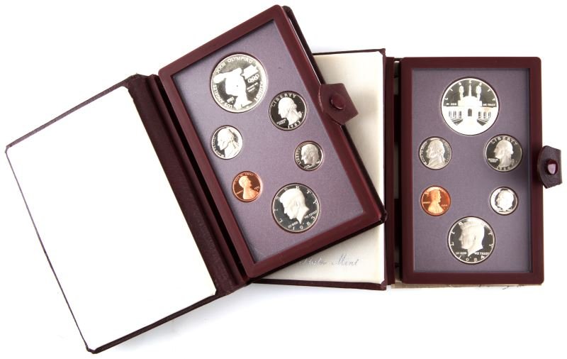 1983 OLYMPIC & 1984 LIBERTY US MINT PRESTIGE SETS: 1983 contains the Discus 90% silver dollar and the 1984 Has the Liberty 90% silver dollar. 1983 is minus the paperwork, both sets are in original boxes.