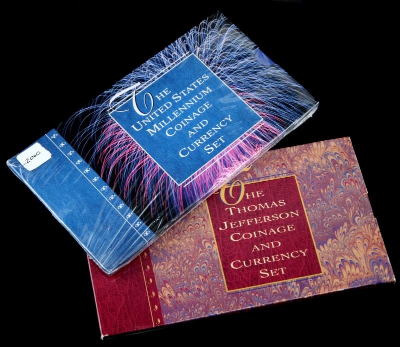 1993 JEFFERSON & 2000 US MILLENNIUM COIN CURRENCY: Two US Mint Coin & Currency sets. One 1993 Thomas Jefferson set (250th Anniversary silver dollar, 1994 Jefferson nickel, 1976 2 dollar note), and one sealed 2000 US Millennium Coinage & Currency set (