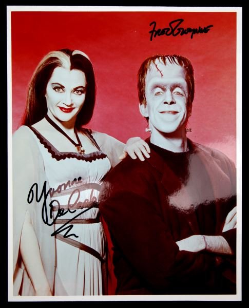 SIGNED PHOTO TWO CAST MEMBERS OF "THE MUNSTERS": Signed publicity photo, 8x10 color, Yvonne DeCarlo and Fred Gwynne, Hermann and Lilly of TV's "The Munsters". Guaranteed authentic. In very good condition.