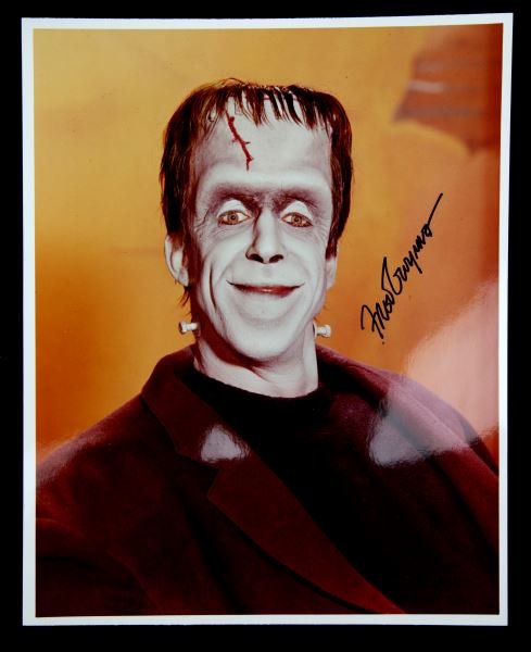 SIGNED PHOTO OF FRED GWYNNE AKA HERMAN MUNSTER: Signed publicity lab photo, 8x10 color, featuring "The Munster's" Herman Munster, better known as Fred Gwynne. Guaranteed authentic, in very good condition.