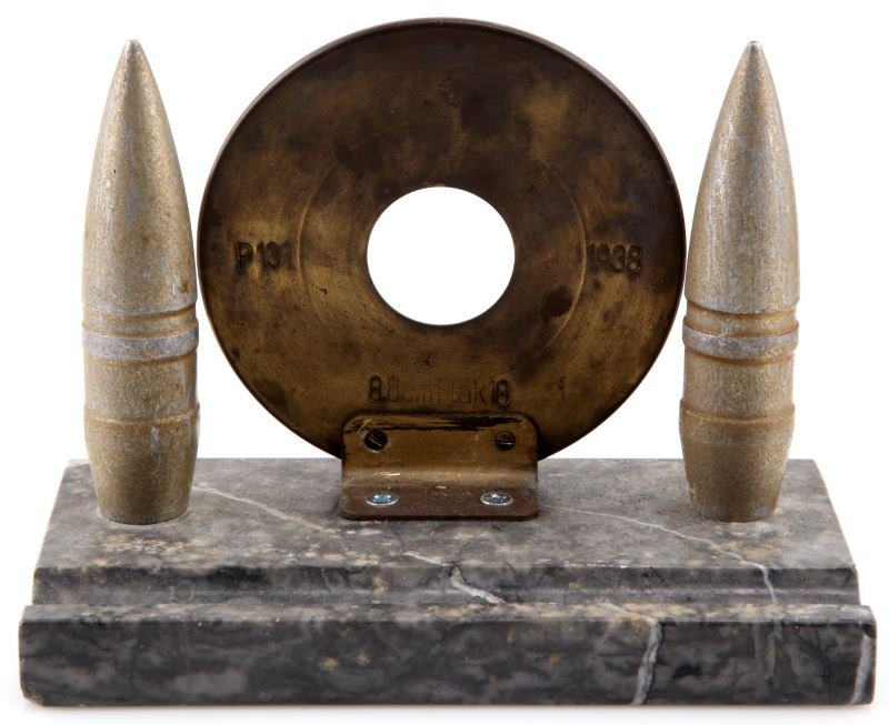WWII TRENCH ART 1938 GERMAN FLAK 18 CANNON: Interwar trench art composed of pieces from a flak cannon. Two flak round end pieces sit on a marble base next to a piece from a German 8.8cm Flak 18 cannon. "P131" and "1938" marked on piece from fla
