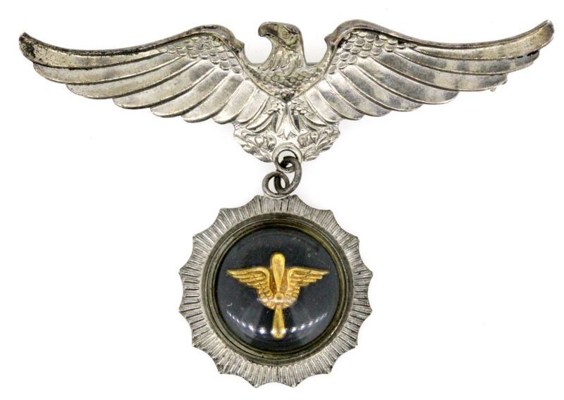 STERLING WWII SWEETHEART BROOCH AIR CORPS: World War II sweetheart wings brooch in sterling silver. The brooch has an encapsulated Air Corps emblem hanging from a bald eagle with outstretched wings. There are no apparent maker's marks on this 