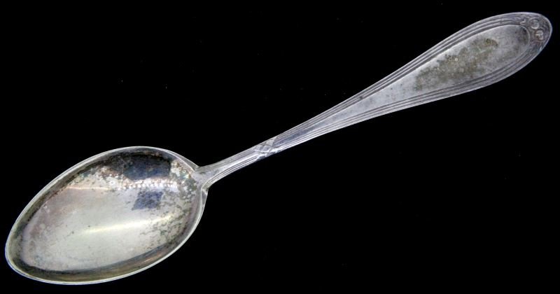 WWII GERMAN TEA SPOON KL BUCHENWALD: 5.5 inch tea spoon marked "DAW K.L. BUCHENWALD" on reverse side. "OKA 20" also appears on reverse side of spoon. This lot has a reserve.