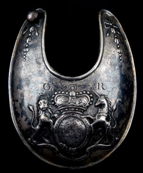 18TH C BRITISH SILVER GORGET KING GEORGE: Antique 18th century silver gorget, likely pre-1795. In May 1796 new regulations abolished silver gorgets. The gorget is adorned with a repousse coat of arms. The silver is tarnished and one of the bu