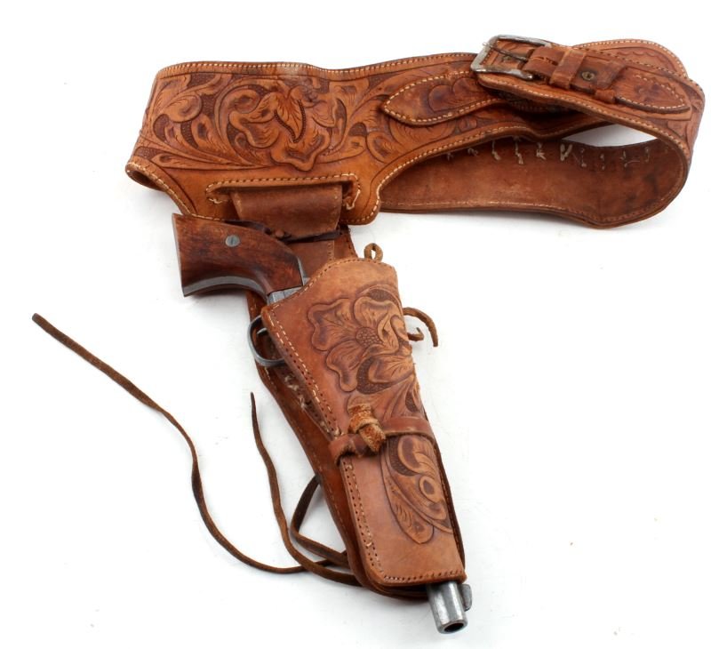 DENIX REPLICA COLT 45 NON FIRING PISTOL W HOLSTER: Replica non-firing Denix Colt 45 pistol accompanied with tooled leather holster. Possibly used as a movie prop in a Wild West film. Denix is a specialized replica gun maker. This item has been artific