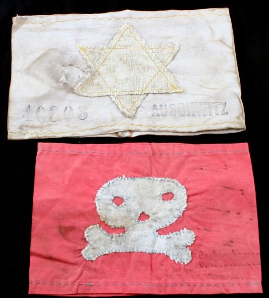 LOT OF TWO CONCENTRATION CAMP ARMBANDS: Lot of two concentration camp armbands. One with a Star of David sewn into face with "40303" and "Auschwitz" marked on the front in faded black. Has some staining and a hole in the front. Another with