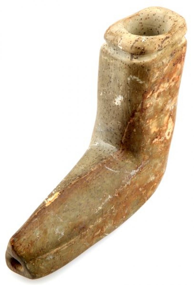 WOODLAND NATIVE AMERICAN GREENSTONE ELBOW PIPE: Woodland period Native American greenstone elbow pipe. Rib to top, smooth green stone with areas of loss. Bottom piece that forms mouthpiece is triangular. Measures 5.5 by 5 inches. Overall very good.