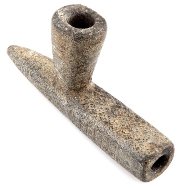 WOODLAND PERIOD CARVED GREY STEATITE PIPE: Woodland period steatite pipe. Cross hatch and tally marks design the pipe. Minor loss at mouthpiece. Solid construction. Very good condition.