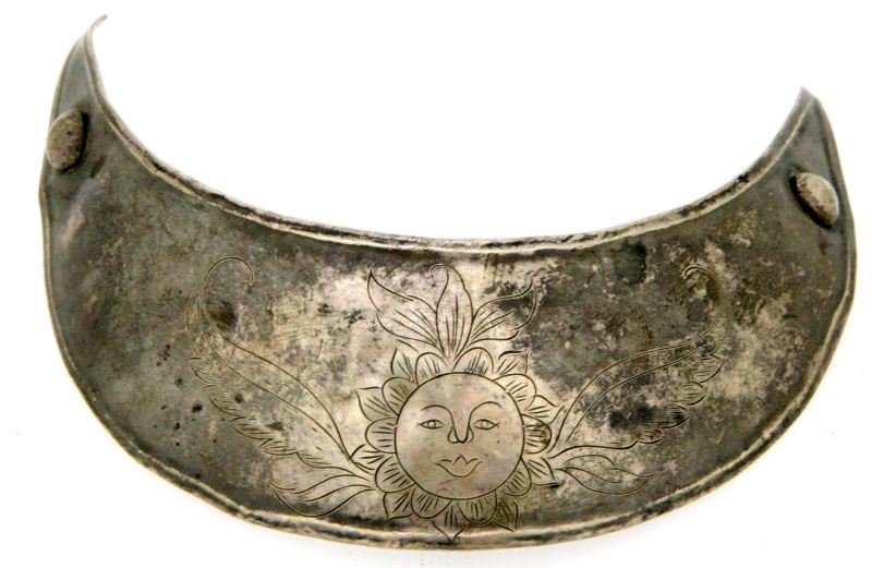 SILVER GORGET WITH ETCHED SUN DESIGN: Silver gorget with sun design etched into face. Measures approximately 4.25x3.5 inches at widest dimensions. Some signs of age. Overall very good condition.