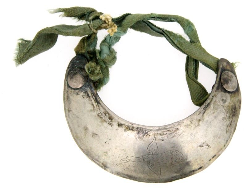 ANTIQUE SILVER TRADE GORGET WITH FLYING DUCK: Antique silver gorget with engraved flying ducks and ribbon. Most likely a silver trade piece. The buttons have some rusting and verdigris. 4 inches wide by 3 winches tall. Very good condition.