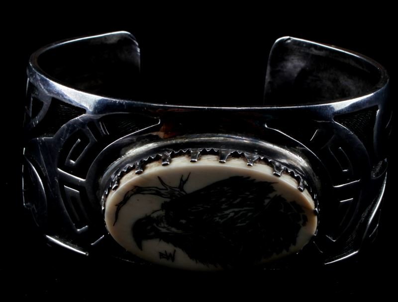 VINTAGE NAVAJO BRACELET CUFF SIGNED E SEHONGVA: Hand signed 'E SEHONGVA' by noted artist Elgene Sehongva. Sterling silver cuff bracelet with an engraving of a bald eagle on bone in the center. Beautiful vintage condition. Measures 1.25 inches wide 