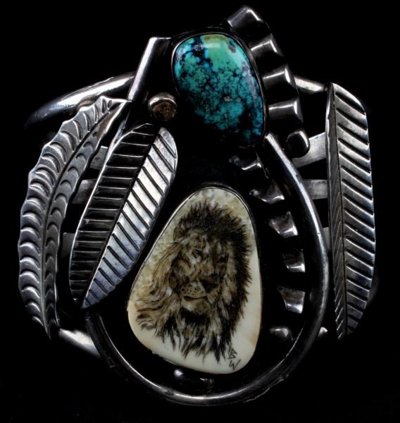 SIGNED SILVER, TURQUOISE, & BONE CUFF BRACELET: Large vintage silver cuff bracelet including a turquoise stone and a lion engraved into bone. Inner cuff marked "Phil T." Largest point of center measures at 3 inches wide, inner circumference is 6 in