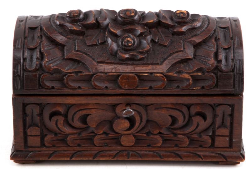 ANTIQUE BLACK FOREST CARVED WALNUT BOX W KEY: Floral carved antique walnut box. Carved in black forest style. The lid is carved with rosettes, side panels with geometric and foliated designs. Miniature trunk. Interior has a carpet-like bottom lin