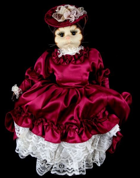 HAND PAINTED VICTORIAN DRESSED PORCELAIN CAT DOLL: Hand painted and numbered, this is a porcelain cat doll with eyelashes, whiskers, and Victorian dress. Very good condition, but her hoop skirt is out of round, and there are small stains on her dress.