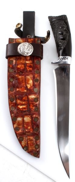HAND CRAFTED STEEL BUTCHER KNIFE W BUFFALO HORN: Hand-crafted steel butcher knife with carved Buffalo horn handle. Indian head carved into handle, silver guard with design, and sharp blade. Measures 14 inches long. New condition. Comes with gator sk