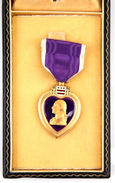 WWII USA PURPLE HEART MEDAL NAMED WITH COFFIN CASE: American WWII Purple Heart medal with original black coffin case. Engraved with recipient's name, Edward Bednarz, on rear. Early war example, over the bar variant. The medal is in very good condition,