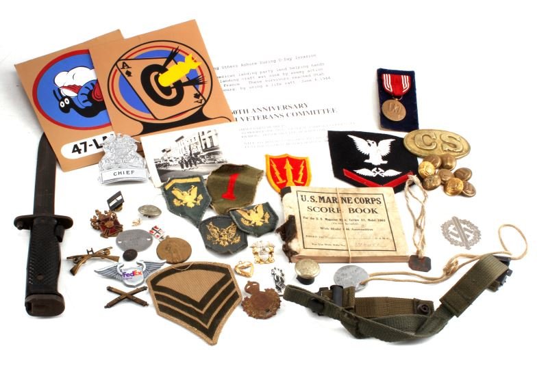 AMERICAN MILITARY GRAB BAG LOT W PINS BADGES WWI: Mixed military grab bag lot with items from the Spanish American War, WWI, and WWII. Some of the items included are as followed: M1 Garand bayonet, WWI dog tags, WWII 1943 dated Aviation Hull Technici