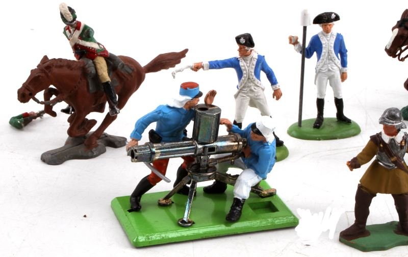 MIXED LOT 10 EURO FIGURINES BRITAINS LTD & OTHERS: Mixed lot of ten European soldier figurines: one Britains gatling gun figurine, two Britains Continental Army soldiers, one Britains swordsman (hand broken off), two Britains cavalry (one with tail br