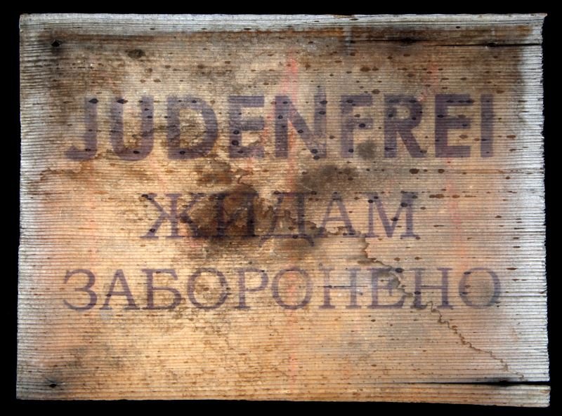 GERMAN WWII SIGN MARKED PROHIBITED FOR JEWS: Double sign is marked in German on one side and in Ukrainian on the other. Some wear and cracks present to sign; overall in very good condition. Unauthenticated as is.