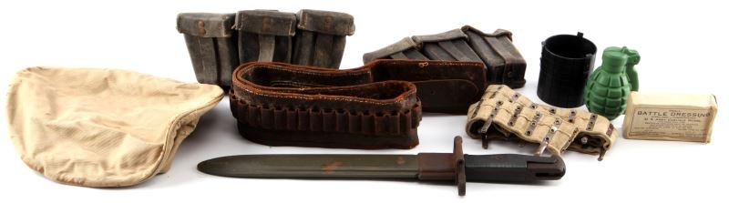 WWII MIXED MILITARY GROUPING WITH GARAND BAYONET: Mixed WWII military grouping. Includes: Maxim MG ammo belt, M1 Garand Bayonet, ammo belt, couple of 3-pocket leather ammunition pouches, US Army wound dressing, and more. Very good condition.