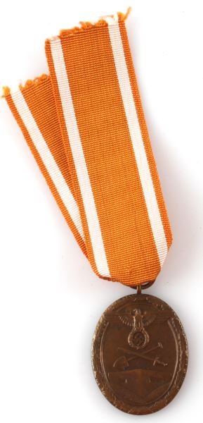WWII THIRD REICH WEST WALL DEFENCE MEDAL: A West Wall Defence medal with ribbon. Features Reichsadler placed over crossed shovel and sword above a bunker. In very good condition.