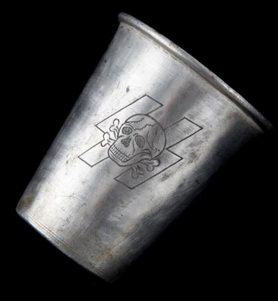 WWII THIRD REICH WAFFEN SS TOTENKOPF SCHNAPPS CUP: Third Reich schnapps cup with totenkopf over SS runes. Made in metal. Measures 2 7/8 inches in height. Item is in very good condition, with some patina over the surface. This lot has a reserve.