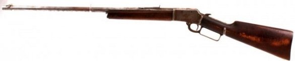 MARLIN MODEL 1892 .32 CALIBER LEVER ACTION RIFLE: Marlin Model 1892 .32 caliber lever action rifle. 24 inch octagonal barrel. Front and rear fixed sight. Wooden stock with crack near firing mechanism. Small piece of wood chipped off bottom of rifle b
