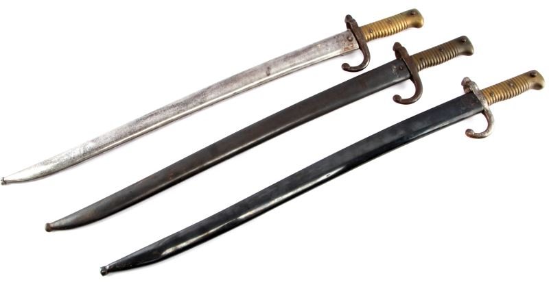 LOT OF 3 FRENCH CHASSEPOT BRASS GRIP BAYONETS: Lot of three Chassepot bayonets. All three are brass-grip variants. Two bayonets have matching scabbard and crossguard serial numbers, and one has an unmarked scabbard. Two are marked "St. Ettienne" a