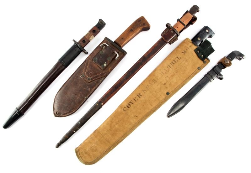 LOT OF 5 INTERNATIONAL BAYONETS AND MACHETES: A lot of five international edged weapons. Contains two machetes, one American and one English. Also contains three bayonets. One bayonet has a minor chip on the plastic grip, and another one needs it