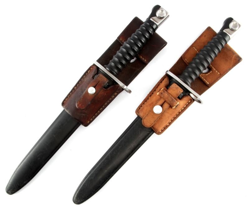 TWO SWISS SIG 57 BAYONETS WITH SCABBARDS AND FROGS: A pair of Swiss Sig 57 bayonets. Both have their original scabbards and leather frogs. The bayonets are in very good condition with bright blades. Leather frogs are supple and free of damage.