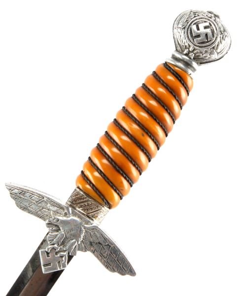 WWII THIRD REICH 2ND MODEL LUFTWAFFE DAGGER: A second model Luftwaffe dagger with scabbard. Maker’s mark has been ground off, but “Solingen” and the remnants of two ovals are present, likely an Eickhorn dagger.. Blade is in good condition,