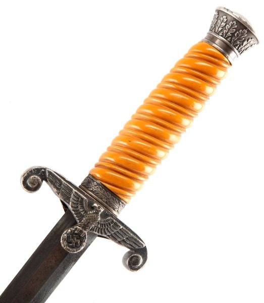 WWII THIRD REICH GERMAN ARMY DAGGER BY EICKHORN: An army dagger with Eickhorn squirrel maker's mark. Blade shows some darkening, but in good condition. The metallic pommel, cross guards and scabbard have a smoky patina that matches in shade. The bak