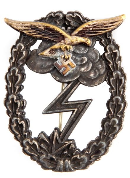 WWII THIRD REICH LUFTWAFFE GROUND ASSAULT BADGE: A Luftwaffe ground assault badge. An oak leaf wreath surrounds an image of an eagle flying over a storm cloud that thunders upon the ground below it. It is in very god condition, which much of the gil