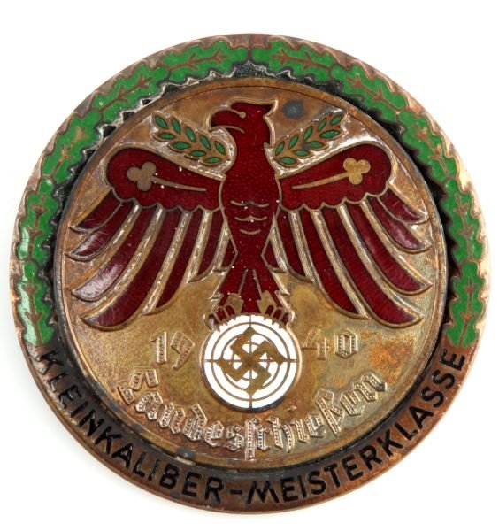 WWII THIRD REICH SMALL CALIBER MASTERCLASS BADGE: A Third Reich 1940 shooting badge made in tombak. The script reads “Landeschiessen Kleinkaliber Meisterklasse” (Land Shootout - Small Bore Master Class). This badge is heavy and well made, with en