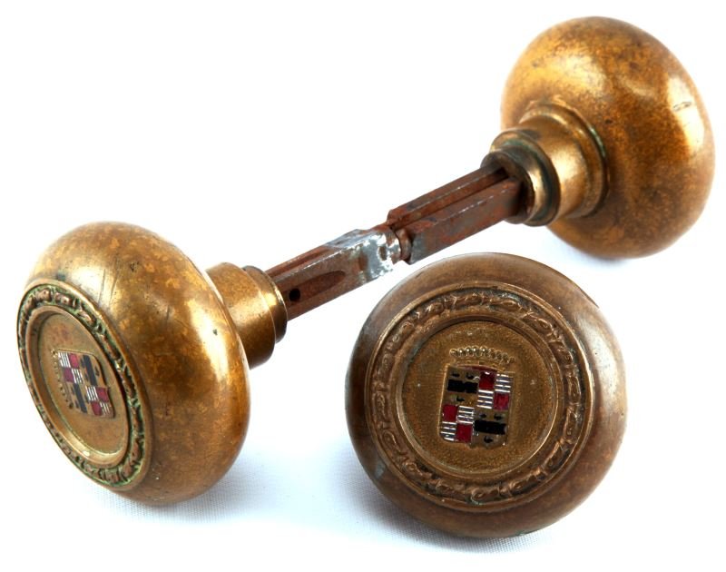 3 VINTAGE DOORKNOB HANDLES CADILLAC HOTEL DETROIT: Three vintage doorknob handles from the Cadillac Book Hotel in Detroit--the worlds tallest hotel at 29 stories at the time of completion in 1924. Doorknobs have the Cadillac emblem. Expected signs of