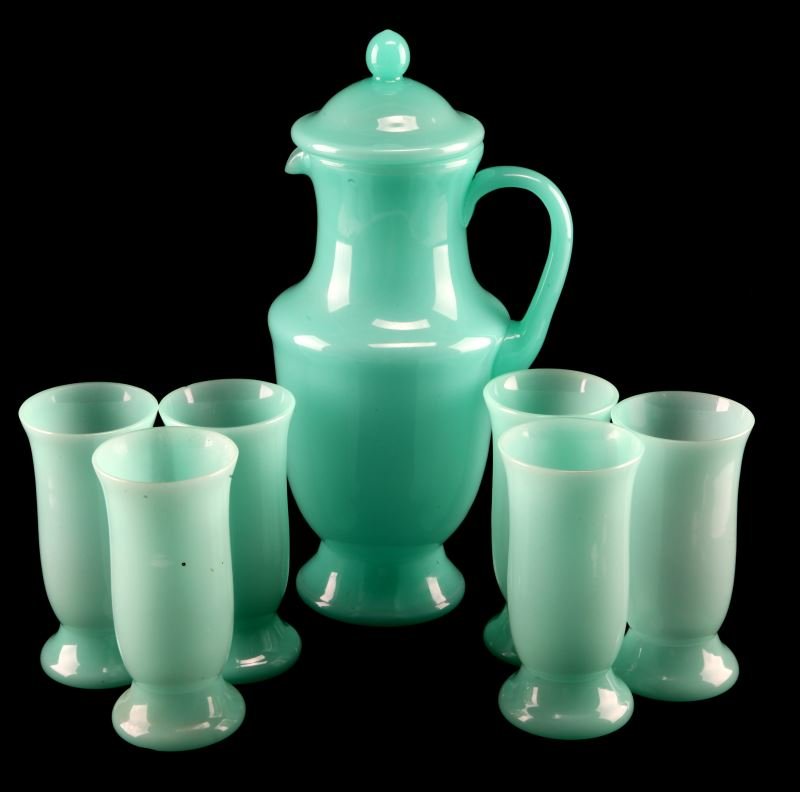 VASELINE JADEITE GLASSWARE W LIDDED PITCHER DUPONT: Unmarked antique vaseline jadeite glassware from the personal collection of the Dupont/Ball estate. This glassware set includes 6 glasses and a lidded pitcher, most likely used in small casual gatheri