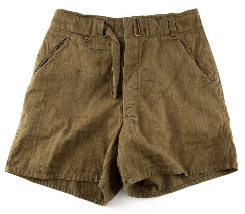 AFRIKA KORPS WWII GERMAN SHORTS THIRD REICH: High quality reproduction of a green pair of WWII Afrika Korps shorts. Button up with built in belt. The buckle has some wear. Size 32. Aged patina and soiling. Overall good condition.
