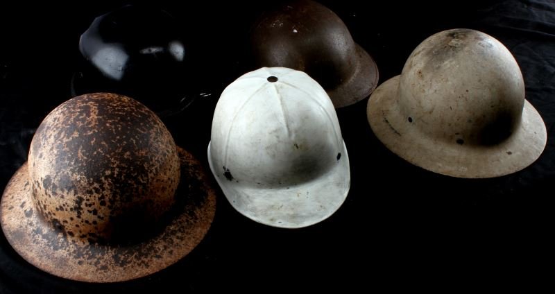 5 HELMET LOT WWI TO MOTORCYCLE TO HORSE & HARD HAT: The Brodie helmet has no suspension, the motor cycle helmet is very good and a size large, two hard hats one is pretty rusted and a horse riding repainted polo type helmet, all in a rubberized bag.