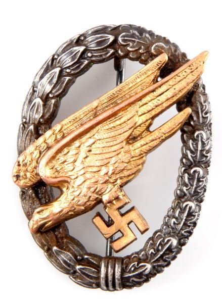 WWII THIRD REICH LUFTWAFFE PARATROOPER BADGE: Rear marked with ASSMAN letter "A". Two piece construction. Rear stickpin with barrel hinge, "C" clasp and 180 degree lie. In good condition with some plating loss. Presumed reproduction.
