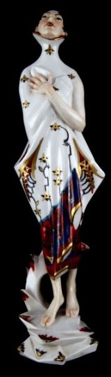 OTTO KRAMER ART DECO FEMALE PORCELAIN FIGURINE: Unmarked porcelain figurine designed by Otto Kramer. This piece was possibly produced Schwarzburger Werkstatten. Hand painted with gold, red, black, and blue. Very good condition; no chips, cracks, or