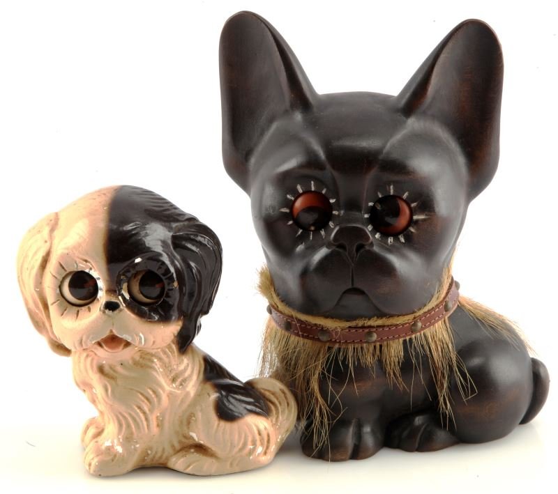 ANTIQUE GERMAN OSWALD ROLLING EYE DOG CLOCK LOT: Lot of two original Oswald rolling eye dog clocks. The first clock is carved out of wood and wears a collar and grass skirt. Measures 8 inches tall. Needs servicing but appears to be working. The smal