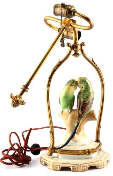 ANTIQUE ROSENTHAL PORCELAIN BRASS BRYANT LAMP 1907: From the collection of Alfred I. Dupont, an antique Rosenthal porcelain and brass lamp. Depicts two parrots kissing, double stand, gilded trim, with dual socket marked (Bryant, patent 1907, 250W). Flo