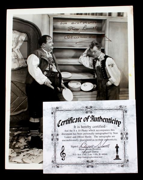 RARE SIGNED PHOTO OF STAN LAUREL & OLIVER HARDY: With guaranteed authentic hand signed autographs, 8x10 black and white lab photograph of comedians Stan Laurel and Oliver Hardy. In very good condition. This lot has a reserve.
