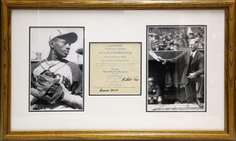 CONNIE MACK SATCHEL PAIGE AUTOGRAH ON PROGRAM: Framed photograph of "Satchel" Paige accompanied with his signature on a program for the launching of the U.S.S Currituck. This ship was a seaplane tender during World War II. Framed piece measures 17