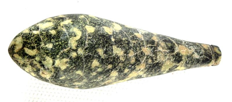 NATIVE AMERICAN GREEN PORPHYRY PLUMMET: Native American green porphyry grooved plummet. The stone appears to have fractures, but is in overall very good condition. Measures 3.25 inches long.