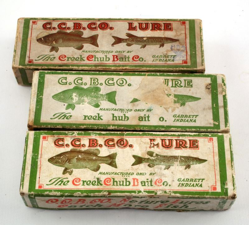 THREE CREEK CHUB BOXES WITH FISHING LURES: Three Creek Chub boxes with fishing lures. Expected signs of age and wear.