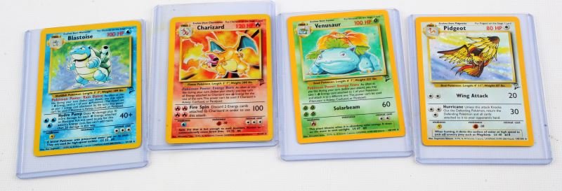 GROUP OF 4 BASE SET 2 FOIL POKEMON CARDS: Includes Blastoise, Charizard, Venusaur, and Pidgeot. Cards are ungraded. Light wear present; overall in very good condition.