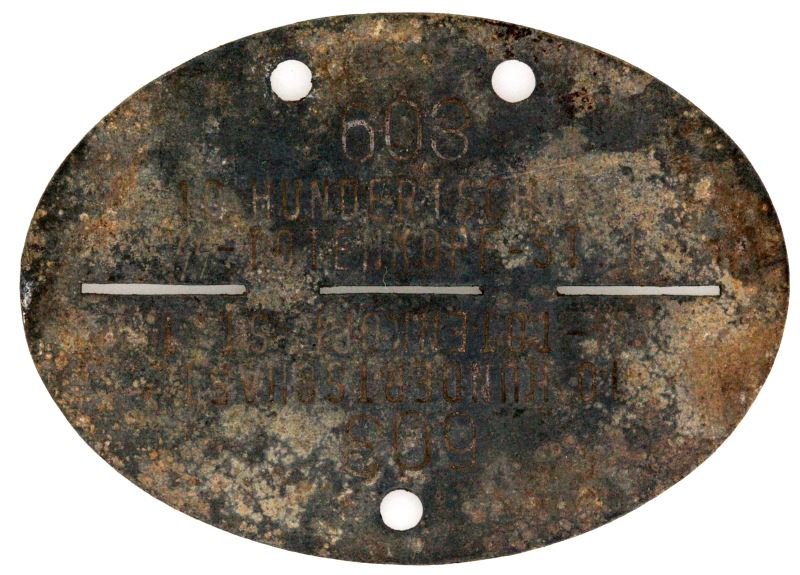 WWII SS TOTENKOPF GERMAN THIRD REICH DOG TAGS: SS Totenkopf WWII German dog tag. Item reads as followed: 603 10 Hundert Schaft (Sig Runes) Totenkopf ST 1. Writing is legible. Condition commensurate to age. 71 mm wide. Three perforations.