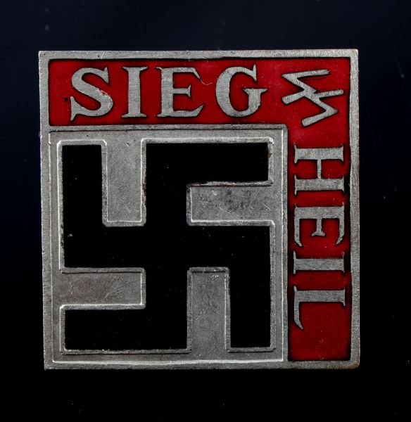 WWII THIRD REICH GERMAN SS SIEG HEIL TINNIE: Measures 1.5 by 1.5 inches. White metal with red and black enamel. Screwback with "WAFFEN SS" stamped onto it. In good condition with some signs of age. Presumed reproduction.